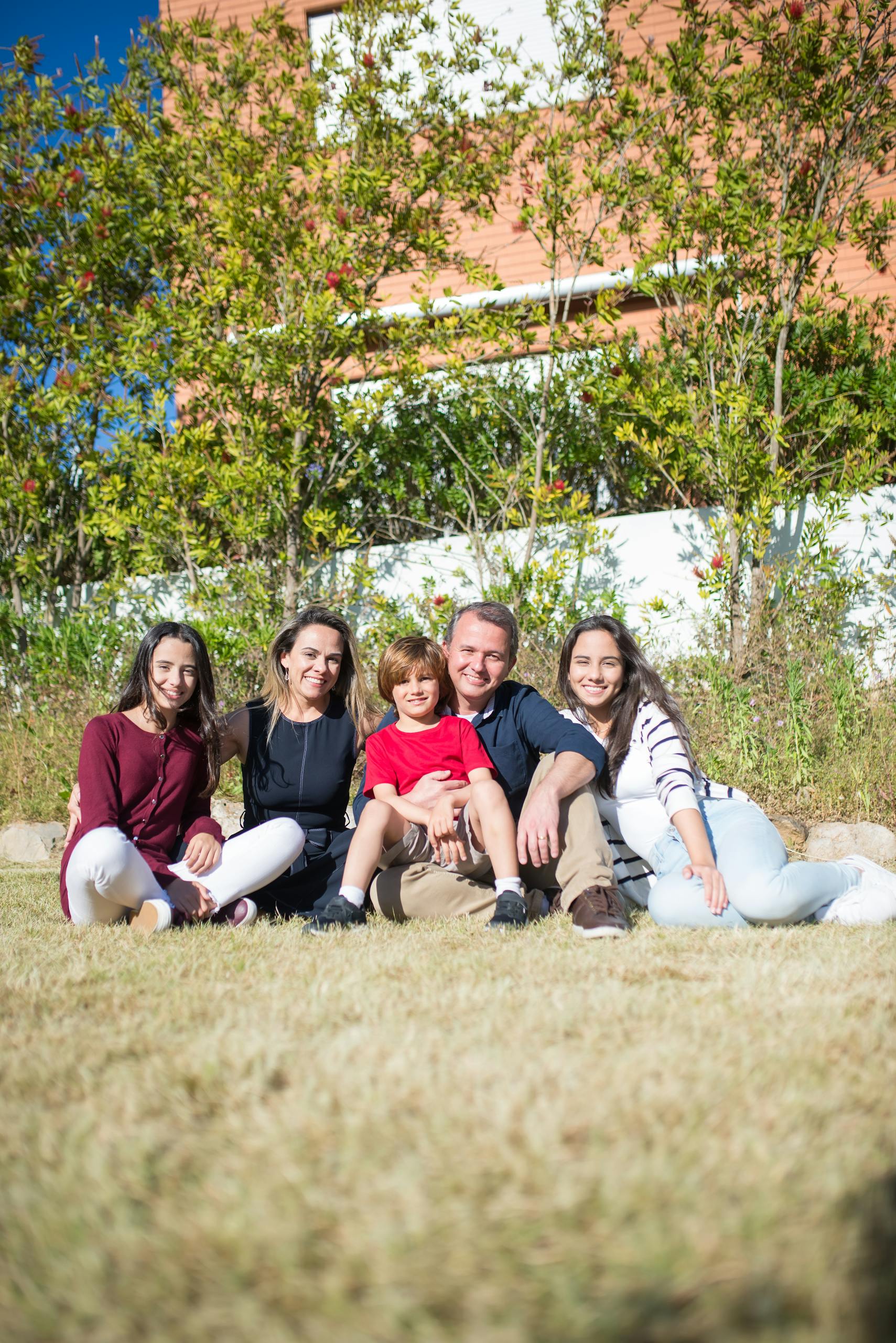 A cheerful family enjoying quality time together outside on a sunny day in Portugal.